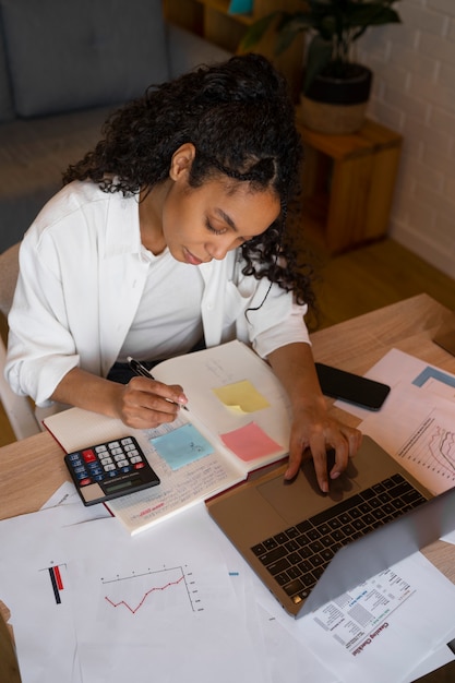 A person reviewing a budget on a laptop, with a Roth IRA savings goal highlighted. The scene emphasizes the importance of budgeting and saving strategies