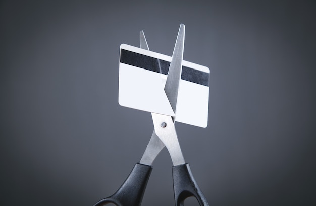A credit card being shredded, symbolizing the act of getting rid of debt.