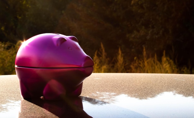 A close-up shot of a piggy bank with a bandage on it, symbolizing the emergency fund as a source of financial healing and protection. Coins and dollar bills are scattered around the piggy bank.