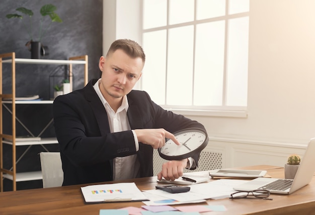 An investor sitting at a desk, surrounded by financial charts and graphs, holding a magnifying glass up to a stock ticker display, symbolizing a thorough analysis of market data.