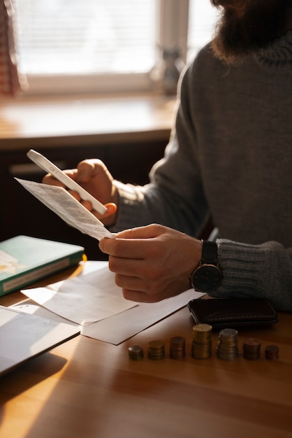 A close-up of a person using a calculator to plan their Dependent Care FSA contributions, with documents and a pen on the desk.