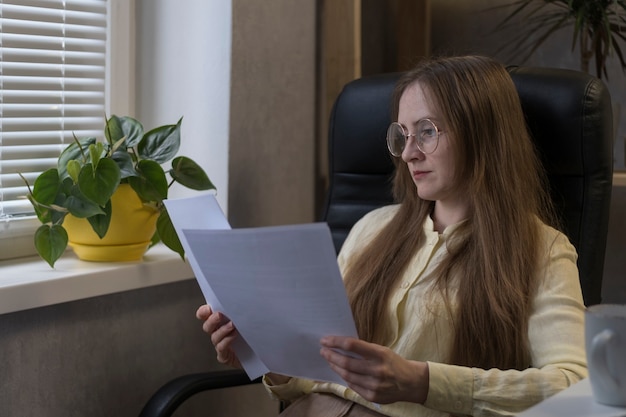 A person reviewing enrollment documents for a Dependent Care FSA, with focus on a highlighted section about eligible expenses and contribution limits.
