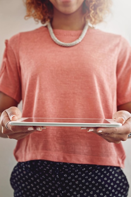 A hand holding a digital tablet displaying a banking app with a recent charitable donation transaction alongside a physical receipt from a charity, illustrating different forms of donation documentation.