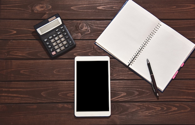 A calculator and a notepad on a desk with financial documents, emphasizing the planning and calculation aspects of maximizing tax credits. The scene is well-organized, suggesting careful management and attention to detail.