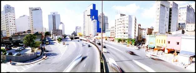 A split image showing a vibrant cityscape symbolizing investment opportunities on one side, and a peaceful retirement scene on the other, linked by a winding road representing financial planning.