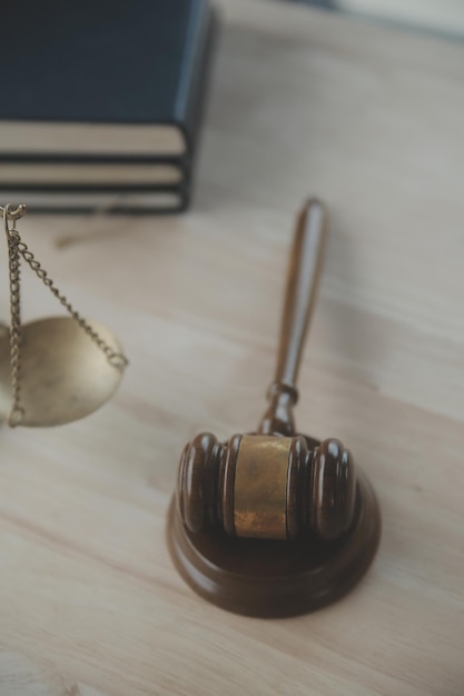 A close-up photograph of a gavel resting on a stack of SEC regulatory documents, with the scales of justice subtly blurred in the background.