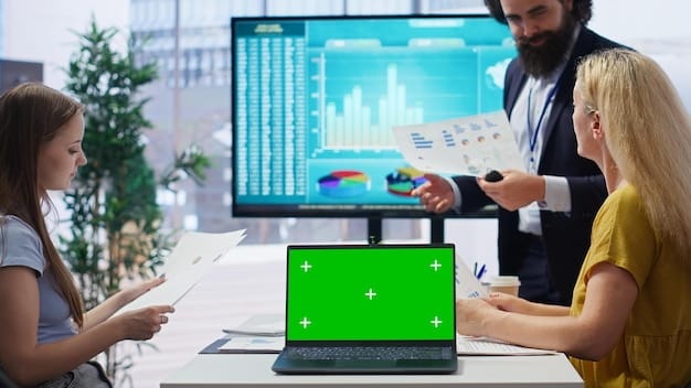 A person using a laptop with graphs and charts displayed on the screen, set in a modern office environment. The focus is on the screen, symbolizing financial analysis.